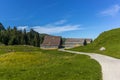 The path leading to the SÃÂ¤mtisersee lake in a late summer afternoon among old wooden stables and cottages in Appenzell