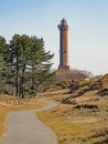 A path leads through the dune landscape to the lighthouse on the island of Norderney, Germany Royalty Free Stock Photo