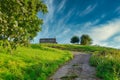 Path through lush green grass leading to small stone cottage in Spanish countryside Royalty Free Stock Photo