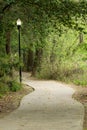 A path in a park with a street light on the left side Royalty Free Stock Photo