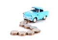 Path paved with dollar coins and a model of a blue car approaching Royalty Free Stock Photo