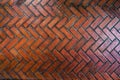The path paved with red brick in herringbone pattern, Red stone walkway herringbone style pattern close-up Royalty Free Stock Photo