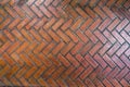 The path paved with red brick in herringbone pattern, Red stone walkway herringbone style pattern close-up Royalty Free Stock Photo