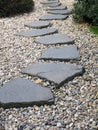 Path of plated stones on gravel bed in Japanese Garden. Royalty Free Stock Photo