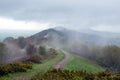 A path on the ridge of the Malvern Hills, with mist covering the hills on a spring day. UK.