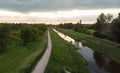 Path and river running to bright cloudy sunset Royalty Free Stock Photo
