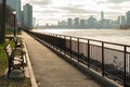 Path with Row of Benches at Queensbridge Park along the East River in New York City Royalty Free Stock Photo