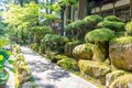 Path and stone wall with moss, and trees, Eiheiji, Japan Royalty Free Stock Photo