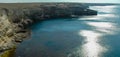 A path of sun glare on the water against the blue sky near the rocks on Tarkhankut, Atlesh Royalty Free Stock Photo