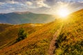 Path though mountain hills and ridge at sunset