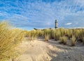 path to the beach at warnemuende, germany with lighthouse tower in the background