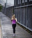 On the path to fitness. Rearview shot of a young woman running along a path. Royalty Free Stock Photo