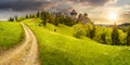 Path to fortress ruins on hillside with forest at sunset Royalty Free Stock Photo