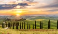 Path to hill house through cypress trees and sunrise view of stunning rural landscape of Tuscany, Italy