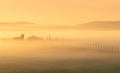 Path to hill house through cypress trees and sunrise view of stunning rural landscape of Tuscany, Italy