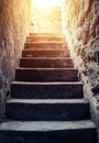 The path to success is represented by a 3D rendering of old concrete stairs ascending to the light Royalty Free Stock Photo