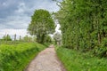 Path through traditional English countryside under gloomy threatening clouds, Cheshire, UK Royalty Free Stock Photo