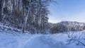 The path is trampled in the snow. Snowdrifts on the roadsides.