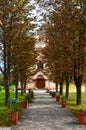 path and tree line towards the church Royalty Free Stock Photo