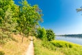 Path among trees to estuary Vistula River to the Baltic Sea at summertime