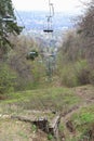 Path under the chairlift in the mountain forest in early spring Royalty Free Stock Photo