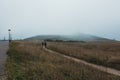 A path for walking and inspiration in foggy weather, creating an unusual mood, tranquility, solitude.