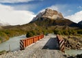 Bridge over mountain river. Snowy mountains. Lago Argentino, Patagonia Royalty Free Stock Photo