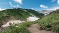 The path winds along the hillside.