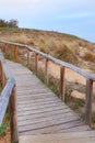 Path from wooden planks providing access to Salento Beach in Baia Verde, Gallipoli, Italy