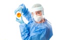 Pathology sceintist in biosecurity suit and PPE holds up a petri dish Royalty Free Stock Photo