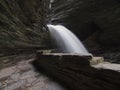 pathway behind a waterfall called cavern cascade at watkins glen state park in new york