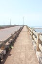 A pathway on the bridge over the creek. Royalty Free Stock Photo