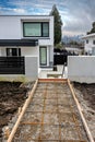 Pathway construction to the main entrance of brand new family house in suburban Royalty Free Stock Photo