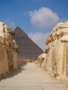 Pathway through Egyptian Ruins with Pyramid in Background
