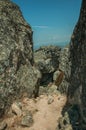 Pathway encircled by big rocks and dry bushes on hilltop Royalty Free Stock Photo