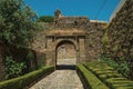 Pathway going toward gateway in stone wall with garden Royalty Free Stock Photo