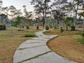 Pathway in the Indrokilo botanical garden, Boyolali, Indonesia. Stepping stones in the grass lawn, the way to success and mileston Royalty Free Stock Photo