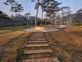 Pathway in the Indrokilo botanical garden, Boyolali, Indonesia. Stepping stones in the grass lawn, the way to success and mileston