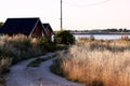 Pathway leading to the red barns at the lake shore