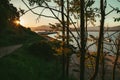 Pathway with  leading to the sea and mountains surrounding the sea and gleaming under the sunset Royalty Free Stock Photo