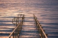 A pathway at sunset leading to calm waters Royalty Free Stock Photo