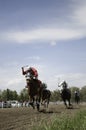 Fast Action Horse Racing okey`s riding fast along a dirt race track Royalty Free Stock Photo