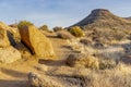 Pathway surrounded by hills, rocks and dry grass Royalty Free Stock Photo