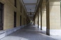 Pathway under the building with giant arches with pillars