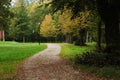 Pathway for walking and jogging in green beautiful public city park on autumn day Royalty Free Stock Photo
