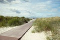 Pathway at white beach with green dune grass at Baltic sea in north Germany Royalty Free Stock Photo