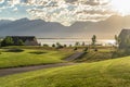 Pathways and fairway on a golf course with view of lake and mountain at sunrise Royalty Free Stock Photo