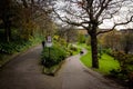 Pathways in Prince Street Gardens, with People walking along the gardens during a rainy day in spring. Edinburgh Royalty Free Stock Photo