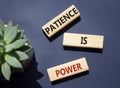 Patience is Power symbol. Concept words Patience is Power on wooden blocks. Beautiful deep blue background. Business and Patience