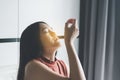 Patient asian woman doing a nasal swab self test rapid antigen testing kit for checking a covid-19 at home Royalty Free Stock Photo